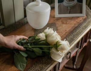 cremation urn on a table with flowers