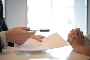 lawyer giving a legal document to a client